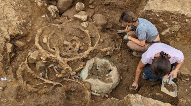 The deposit of iron tyres in Trench 1 shortly after being uncovered.