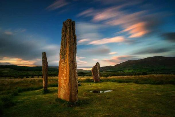 Machrie Moor on the Isle of Arran at sunset with two magnificent standing stones in the foreground. Source: swen_stroop / Adobe Stock