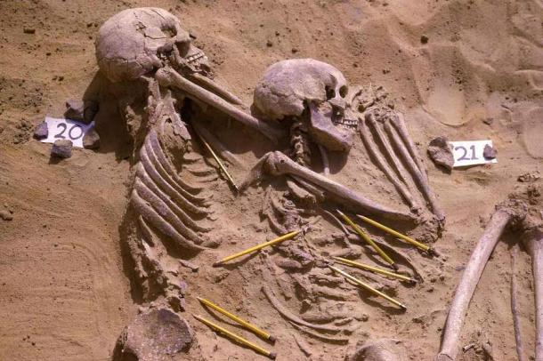 Archival photograph showing a double burial from the Jebel Sahaba cemetery in Sudan, with pencils marking the position of associated lithic artifacts. Source: Wendorf Archives of the British Museum/Scientific Reports