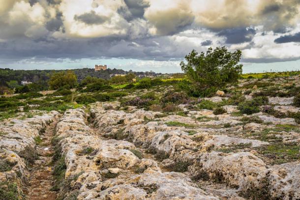 Maltese cart ruts near Buskett, Malta, with Verdala Palace visible in the distance. 