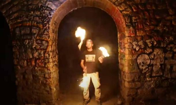 A ‘cataphile’ inside the Paris catacombs. Source: YouTube Screenshot / The New York Times.