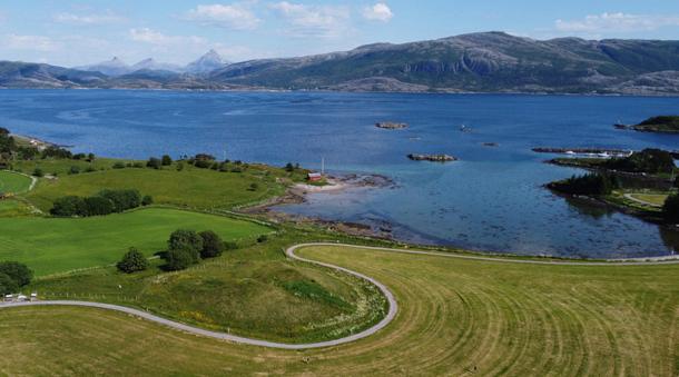 Herlaugshaugen (in the center foreground) from the west, looking towards the strait and the mainland in the background