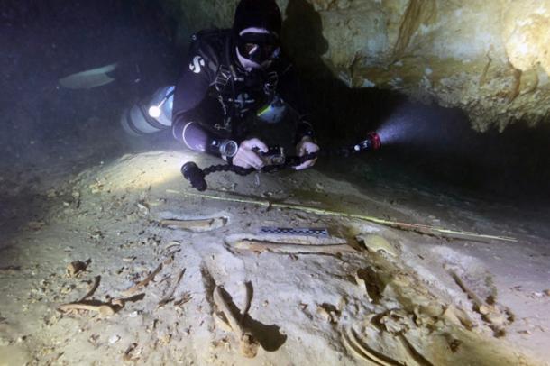 Underwater archaeologist Octavio del Río photographs the prehistoric skeleton discovered inside the flooded cave system in Actun, near Tulum, Mexico