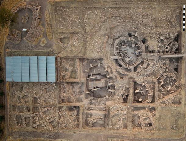 Aerial view of the main excavation area at G&ouml;bekli Tepe, with large round stone enclosures ringed by T-shaped pillars and smaller rectangular buildings beside them