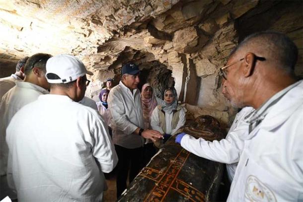 Egyptian officials and archaeologists inspect one of the newly uncovered coffins at Dra Abu El-Naga,