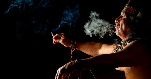 Marijuana and other plants have been used for medicinal, spiritual, and recreational purposes since time immemorial. The pictured Amazonian shaman uses ayahuasca ritualistically. Source: Ammit / Adobe Stock