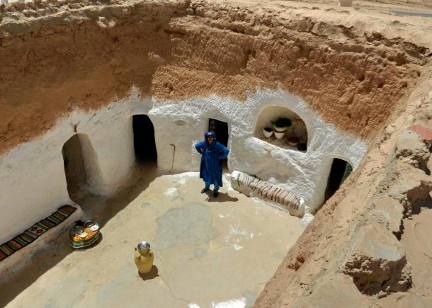 A whitewashed sunken courtyard in the Matmata area of Tunisia, with doorways cut into the surrounding walls
