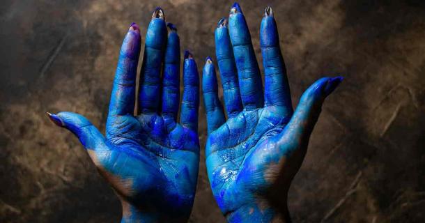 Representative image of hands covered with Maya blue pigment. Source: Generated with Adobe Firefly