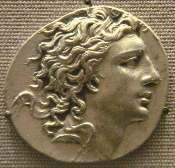 A coin showing the profile of a young king with long, windswept hair