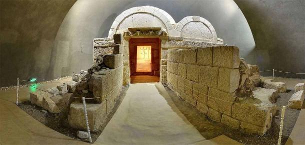 In the foreground of this photo, you can see the original entrance to the tomb of Sveshtari, glowing golden in the background of this image. (Interact-Bulgaria / CC BY-SA 4.0)