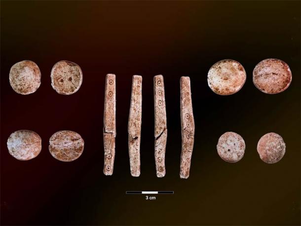 The four sides of a dice, as well as the front and back sides of several other Iron Age game pieces found in western Norway. (University of Bergen)