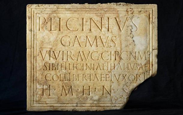 A funerary plaque with the deceased’s name and epitaph