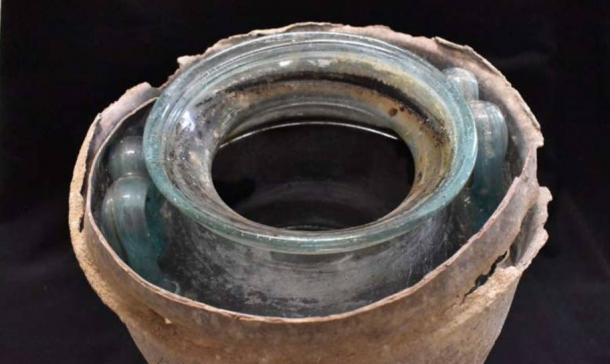 The ancient wine was discovered in this glass vessel, within a lead basket