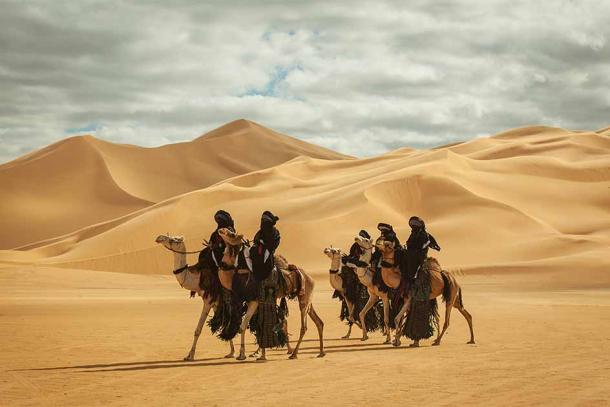A group of Tuareg men in the desert. (Barudi / Adobe Stock)