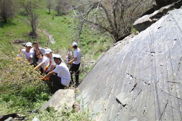 Group of researchers at the petroglyph site. (Photo credit: Department of Internal Policy of the Akimat of the Zhambyl Region)