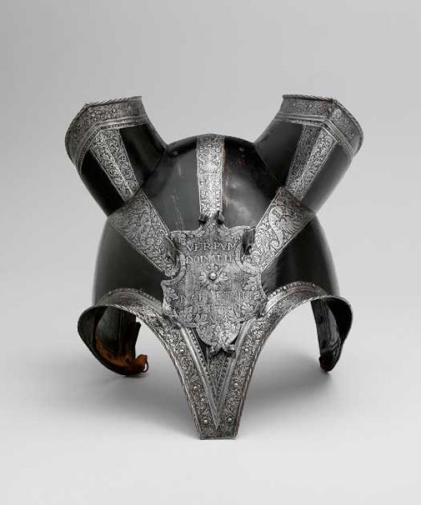 German half-shaffron (horse's head defense), ca. 1553. The shaffron is constructed of a main plate that tapers to a deep, blunt point in the middle of the nose, with bold flanges over the eyes and deeply arched sides. The ear guards are separate. The escutcheon plate has scrolled edges and is etched with foliage on a dotted ground against which is set the Latin inscription VERPUM DOMINI MANET IN ETERNVM ("The Word of the Lord endureth forever" [I Peter 1:25]). The motto on this shaffron was a popular one and is associated with several German princes. (The Met / Public Domain)