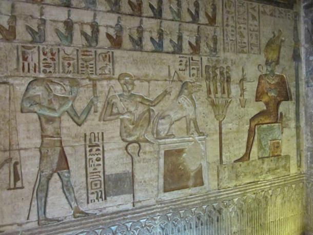 Thoth, left, on a relief depicting the weighing of the heart ritual in the afterlife, with Osiris seated on the right. Deir el-Medina
