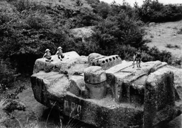A historical photo of the monolith of Tlaloc in Coatlinchan, Mexico. 