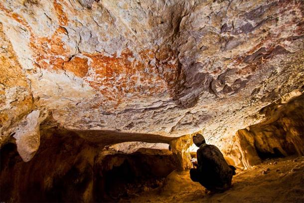 Figurative art, found in a cave in East Kalimantan, Borneo, depicts wild cattle and dates to about 40,000 years ago. Some researchers correlate the position of certain paintings with the position of the stars and the moon. (Pindi Setiawan / Griffith University)