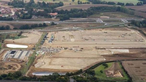 The enormous lorry park under construction as of this writing, with St. Mary’s Church in the lower right green zone. (Change.org)