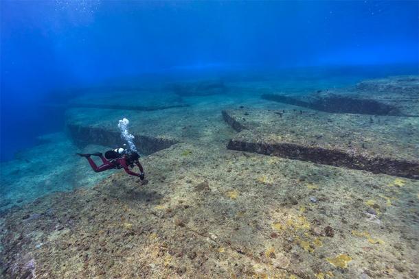 A diver inspecting the underwater site of Yonaguni, a key site in megalithic Japan. (hoiseung jung/EyeEm / Adobe stock)