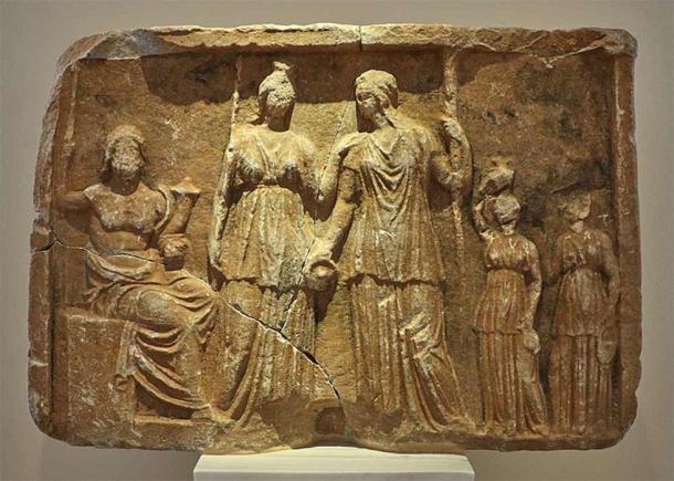 Pluto enthroned with a scepter and cornucopia. In front of him stand Persephone with a scepter and Demeter with a bowl and torch from Tegea. National Archaeological Museum of Athens. Athens, Greece (George E. Koronaios/ CC BY-SA 4.0)