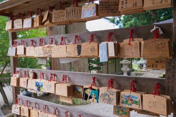 Traditional wooden prayer tablets (ema) at Shirakawa Hachiman shrine in Shirakawago, Gifu, Japan, a famous historic site. (beibaoke / Adobe Stock)