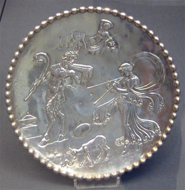 One of a pair of silver dishes from the Mildenhall Treasure; decorated with figures of Pan, a nymph and other mythological creatures, all in relief; ring foot on underside; inscribed 'EVATTPLOY' on the base. (British Museum / CC0)