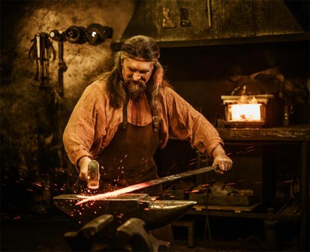 Representation of medieval blacksmith forging a sword. (Nejron Photo / Adobe stock)