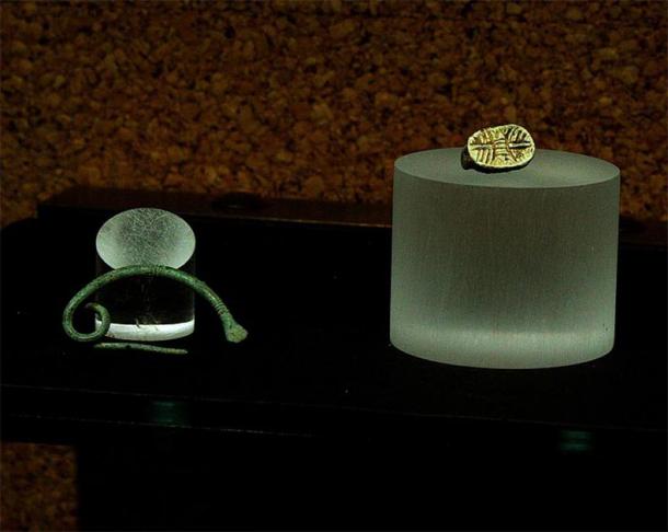 Scarab and fibula found in tomb 25. (DedaloNur/CC BY SA 3.0)