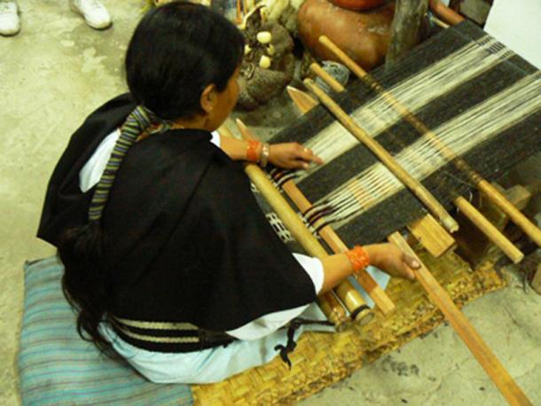 An indigenous woman using a traditional loom. (Author provided)