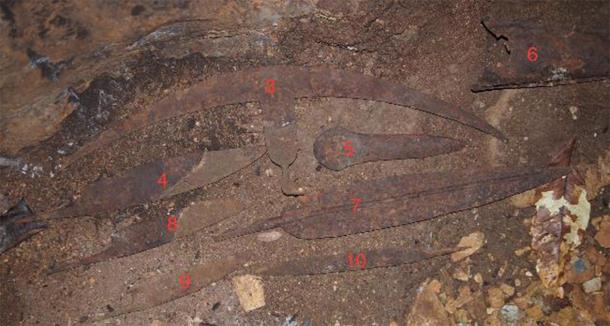 Some iron objects found in the cave. Before realizing the nature of the discovery, a few types of the objects were assembled for a picture: currency-blades, spear head, axe, gong, and an unknown type in form of a crescent. (NOT Engineers)