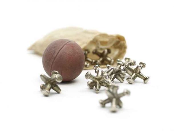 Metal knucklebones spilled from a bag along with the bouncing ball: this is a game of dexterity and in ancient Greece they actually used similarly shaped sheep ankle bones. (The Children's Museum of Indianapolis / CC BY-SA 3.0)