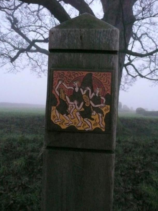 A plaque depicting the legend of Long Meg and her daughters; a coven of witches dancing on the moor before they were cast into stone.