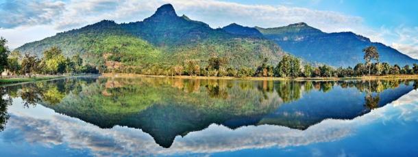 Sacred lingam-shaped Phou Khao mountain reflects in the baray (irrigation pond) of the Vat Phou temple complex