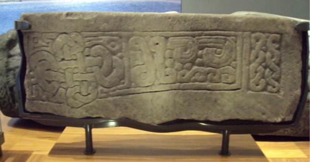 Tenth-century or later lintel stone fragment showing a cross-shaped knot inspired by the carving styles of Viking England. Now in the Kelvingrove Art Gallery and Museum, Glasgow, Scotland