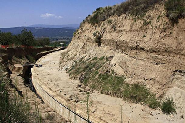 A marble wall surrounds the enormous Kasta Hill burial mound in Amphipolis