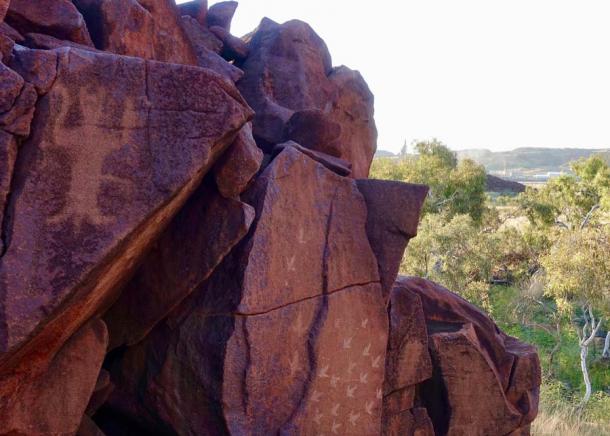 A modern ammonia plant sits side by side with ancient rock art at Murujuga National Park. (Marius Fenger / CC BY-SA 4.0)