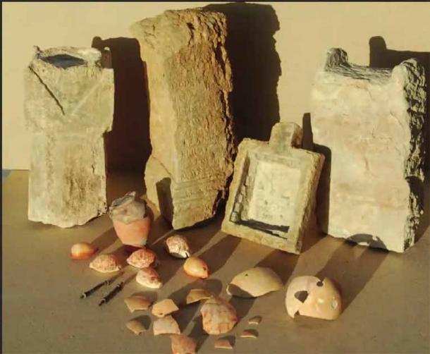 Selection of cult objects from a temple in Berenice, including incense altars, reused inscribed altar, temple pool, cowry shells, bronze rods, painted ostrich eggshells, pot with lid containing a votive deposit of lunate ornaments (Steven Sidebotham)