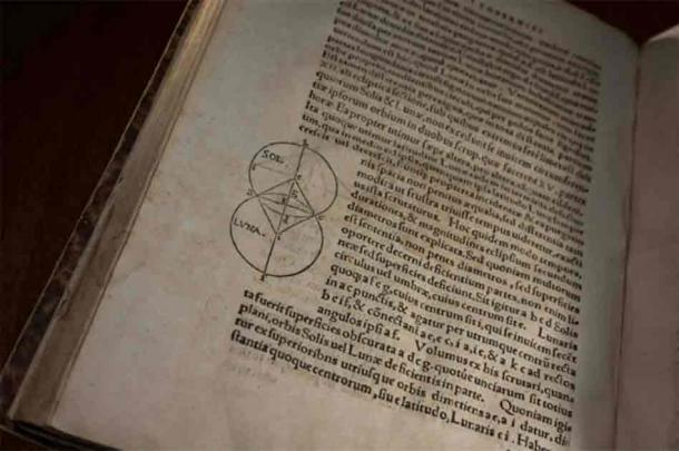 OFF-CENTER: First printed in 1543, De revolutionibus orbium coelestium (On the Revolutions of the Heavenly Spheres) by Renaissance astronomer and mathematician Nicolaus Copernicus posited a heliocentric model of the universe as an alternative to the then-widely accepted Earth-centric one. The University’s copy of the book dates to 1566. (University of Rochester photo / J. Adam Fenster)