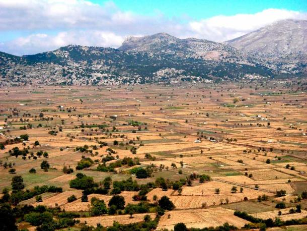 This panorama of the Lasithi Plateau shows the Hagios Charalambos cave location, at the base of the white stone mountains, where scientists may have found the explanation for the Bronze Age collapse in the Mediterranean and Near East. (Haloorange / Copyrighted free use)