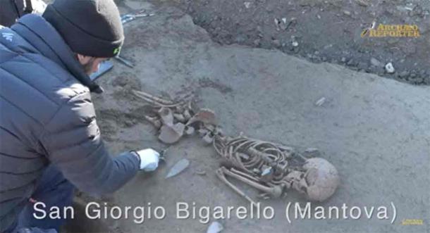 Position of one of the burials, including a dagger placed near the body. (YouTube Screenshot/ArchaeoReporter)