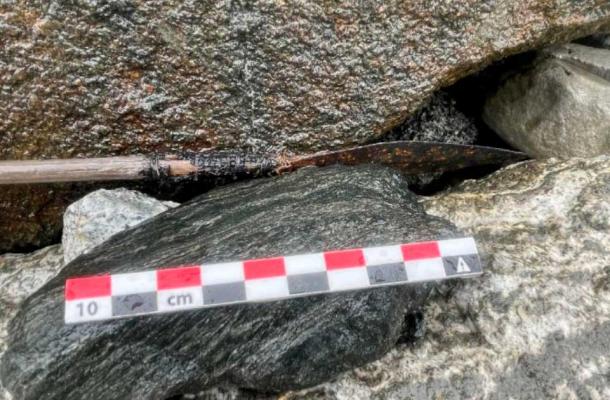 The projectile end of the latest ice patch arrow lodged between stones on the lower edges of Norway’s Langfonne ice path. (Secrets of the Ice)
