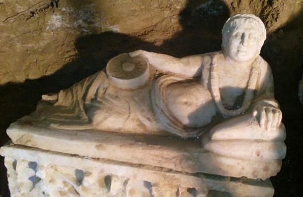 A reclining figure on the lid of one of the marble urns found in the tomb.