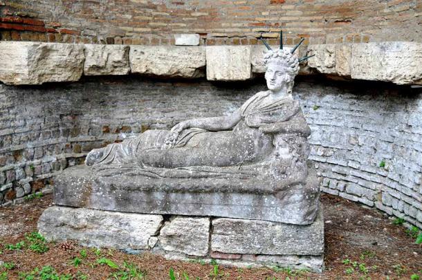 A statue of a reclining Attis, after the emasculation. In his left hand is a shepherd's crook, in his right hand a pomegranate. His head is crowned with bronze rays of the sun and on his Phrygian cap is a crescent moon. (Dennis Jarvis / CC BY SA 2.0)