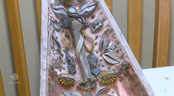 A screenshot from a CBC video of a reliquary and objects inside, found in an attic in Canada