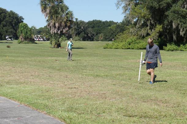UGA doctoral candidate Jake Lulewicz (foreground) and UGA doctoral student Isabelle Lulewicz (background) running the gradiometer (magnetic survey) at Santa Elena.