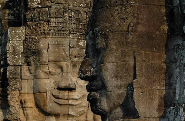 The serene stone faces gazing out from the many towers at Bayon Temple, Cambodia.
