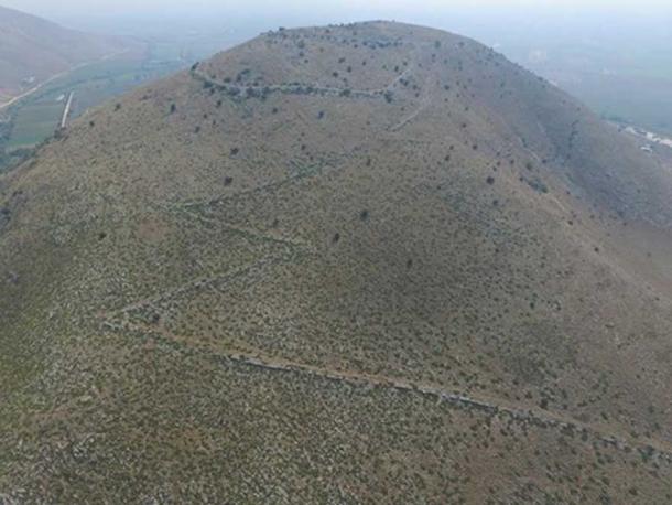 The site with the road leading up towards it.