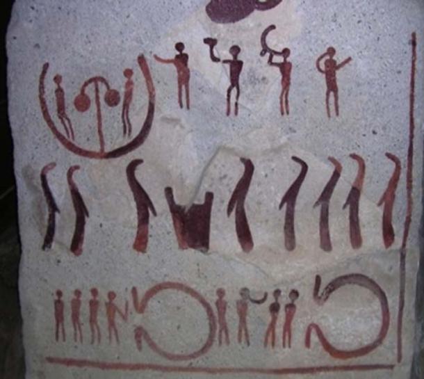 One of the slabs of stone shows people (eight in long robes)